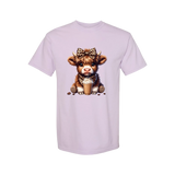 Dixie Magnolia Market light purple graphic tee with a cute Highland cow wearing a leopard print bow and bandana, holding an iced coffee.